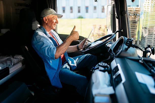 istock Senior truck driver using digital tablet and gesturing thumbs up 2230629881