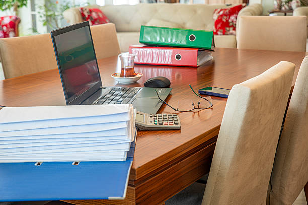 istock Computer and office folders on the dining table at home 2230630725