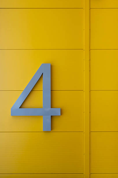 istock Large Number Four Sign On Yellow Industrial Wall Surface 2230634085