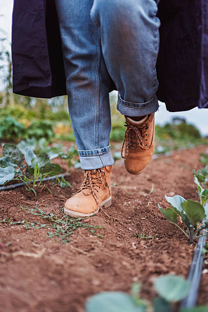 istock Farmer walking in cultivated field wearing work boots and jeans 2230635189