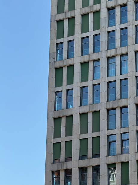 istock Modern High-Rise Building with Green Panels and Glass Windows 2230636739