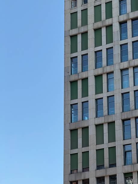 istock Modern High-Rise Building with Green Panels and Glass Windows 2230636741