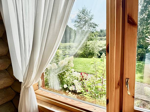 istock Natural Light Through White Linen Curtains on Wooden Window Background 2230638392