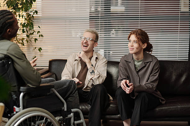 istock Man With Disability Chatting With Colleagues 2230638494