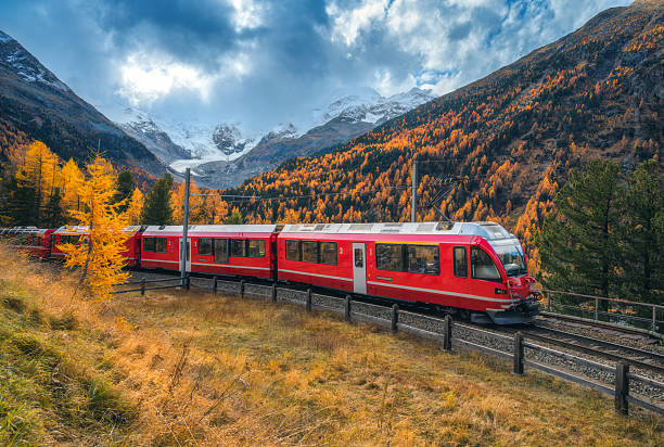 istock Red Bernina Express train passing through colorful autumn forest 2230639054