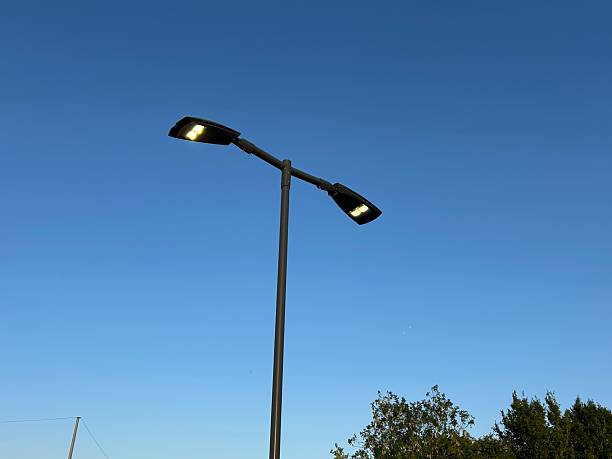 istock Modern Streetlight Illuminated Against a Clear Evening Sky 2230640602