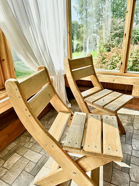 istock Rustic Style Wooden Dining Chairs in Cabin with Floor-to-Ceiling Windows 2230641837