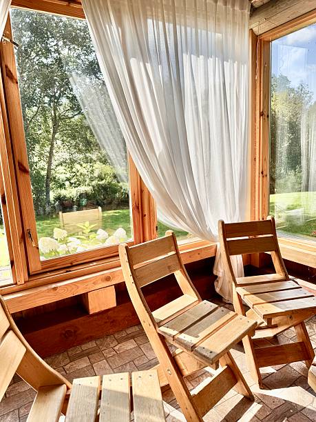 istock Rustic Style Wooden Dining Chairs in Cabin with Floor-to-Ceiling Windows 2230641970