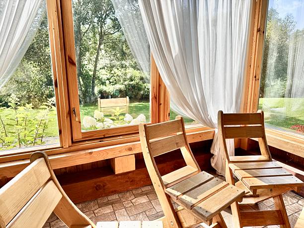 istock Rustic Style Wooden Dining Chairs in Cabin with Floor-to-Ceiling Windows 2230642299