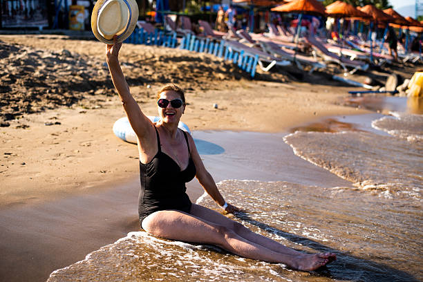 Senior woman relaxing on a sandy beach