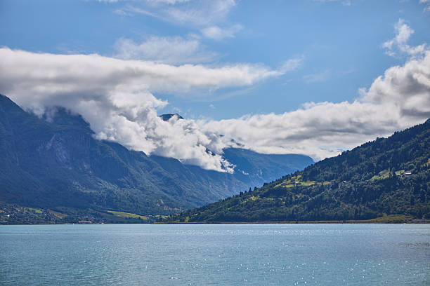 istock Breathtaking Mountain Landscape With Clouds Overlooking a Calm River 2230648101