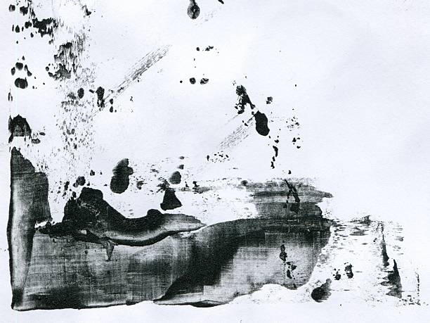 A splash and drag of black gritty paint on textured white paper