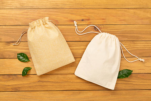 istock Small eco sack on wooden background, top view 2230650276