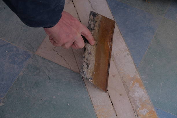 istock The man is engaged in repairs, works with a drill and other tools, hands and objects for repair are visible 2230657238