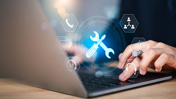 istock IT support and digital tools concept. Person using laptop with glowing wrench and screwdriver , representing system maintenance, tech service, customer support, and online troubleshooting in business 2230658819