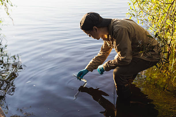 Scientist takes water samples into test tube