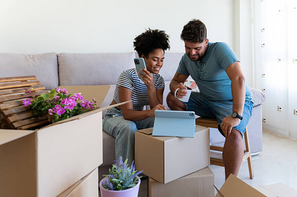 istock Couple organizing new home using digital tablet and smartphone 2230665928