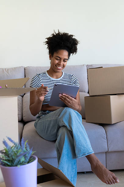 istock Woman organizing her move using a digital tablet in new apartment 2230665966