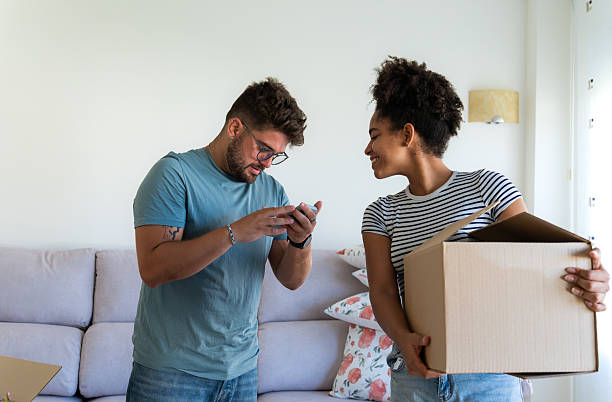 istock Young couple moving into new apartment using checklist app 2230666422