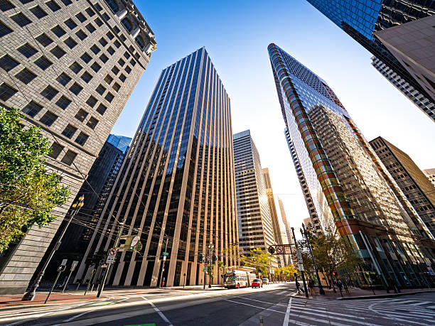 Wide angle view of modern skyscrapers in downtown San Francisco during golden hour, highlighting the city's urban architecture and financial district skyline