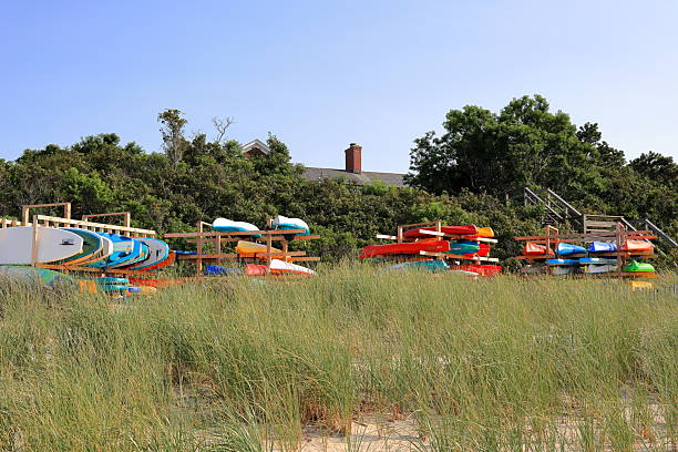 Brewster, MA, USA - July 30th 2025 - Colorful kayaks and stand up paddleboards for rent along Cape Cod Bay