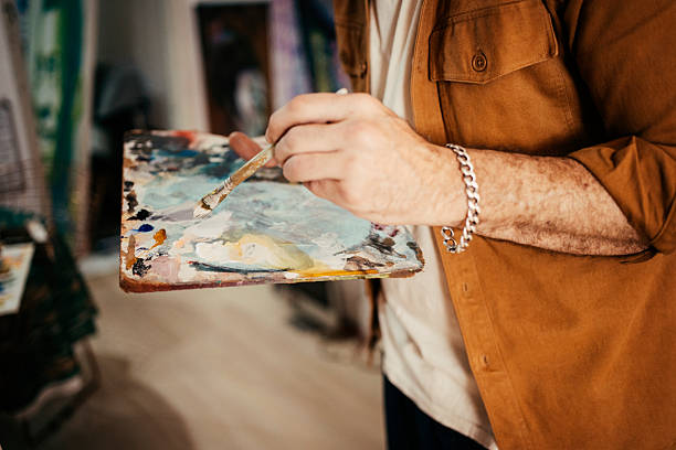istock Artist painting in his studio 2230675294