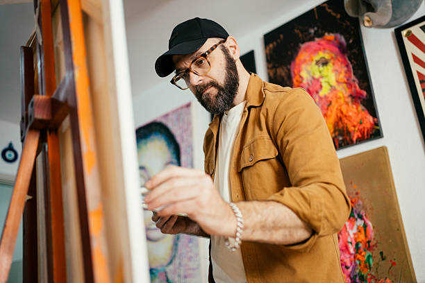 istock Artist painting in his studio 2230675313