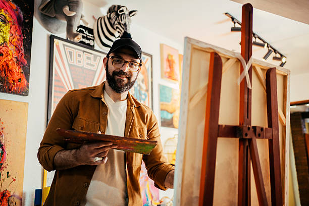 istock Artist painting in his studio 2230675321