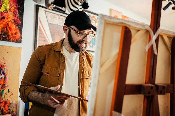 istock Artist painting in his studio 2230675333