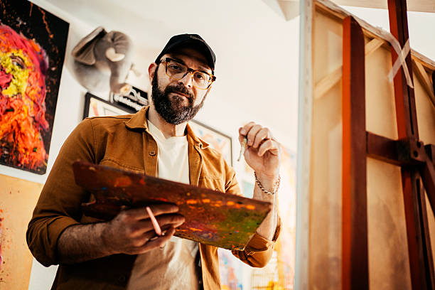 istock Artist painting in his studio 2230675338