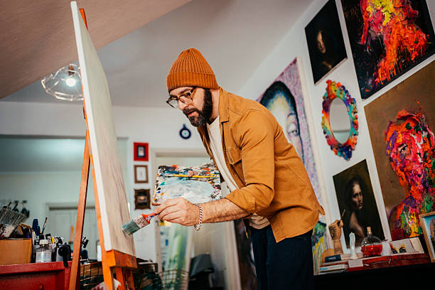 istock Artist painting in his studio 2230675369