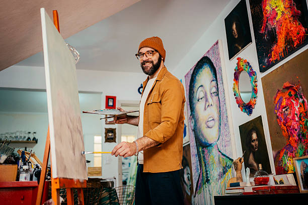 istock Artist painting in his studio 2230675373