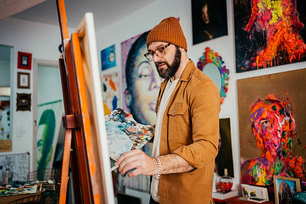 istock Artist painting in his studio 2230675379