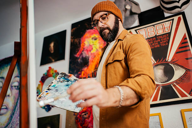 istock Artist painting in his studio 2230675395