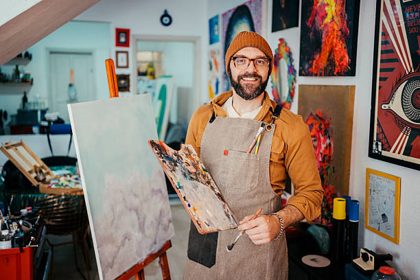 istock Artist painting in his studio 2230675419