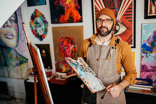 istock Artist painting in his studio 2230675420