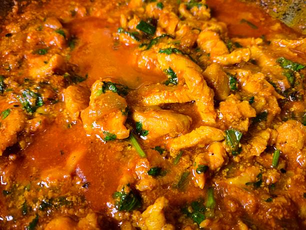 Cooking chicken tikka masala in pan