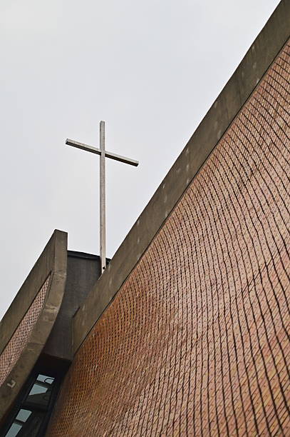 Cross on iconic Luce Chapel designed by architect I.M. Pei featuring curved concrete walls resembling praying hands, representing famous modernist architecture landmark at Tunghai University.
