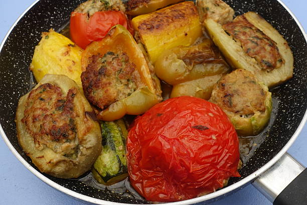 Mixed vegetables stuffed with spicy minced beef while cooking Yellow zucchini Tomato Yellow pepper Eggplant Potato