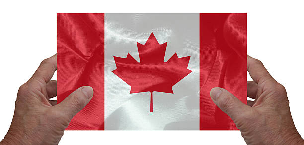 istock Hands holding the Canadian national flag 2230688425