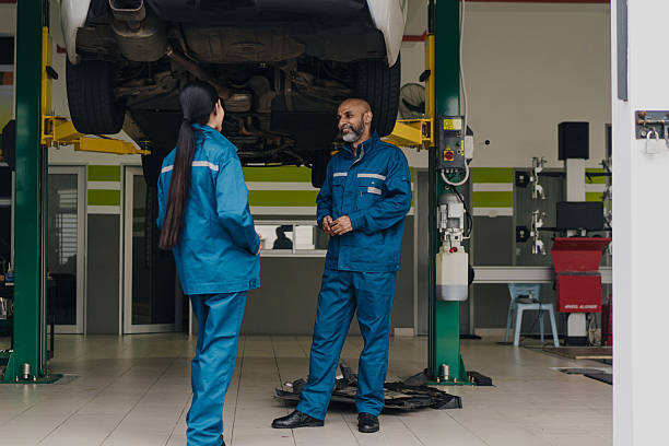 istock Asian auto mechanics co workers taking a break and having a conversation 2230688951