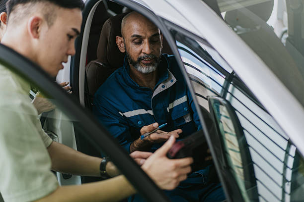 istock Asian car mechanic diagnosing and inspecting a car for customers 2230690463