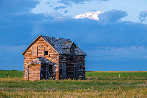istock Dark storm clouds over an old, abandoned building on the Saskatchewan prairies 2230696555