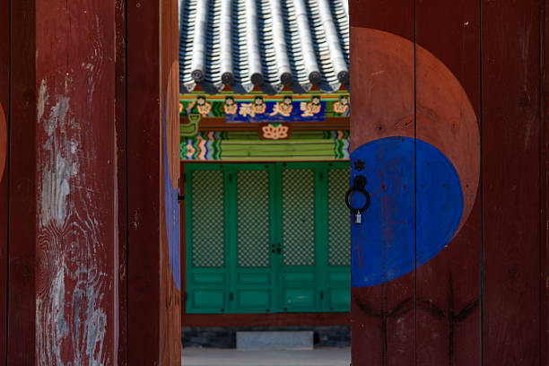 Korean Green wooden door with geometric lattice design and metal handles.