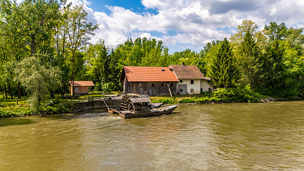 Graz, Austria - 17.08.2019: View at Mur river, Murinsel on bridge, people enjoy beautiful summer. Travel destination.