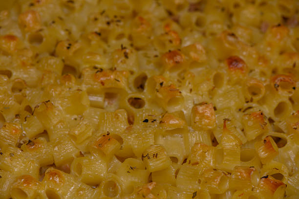 Closeup of a homemade macaroni cheese casserole with creamy cheese sauce and baked golden top, perfect comfort food for any meal.