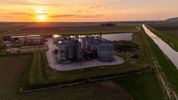 istock Small Sustainable Farm With Solar Panels and Silo at Sunrise 2230702011