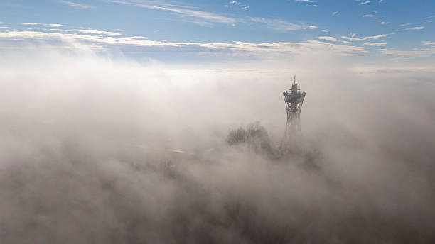 istock Communication Tower Amidst Dense Fog at Sunrise 2230703142