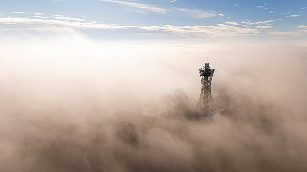 istock Communication Tower Rising Through Fog at Sunrise. Lendava 2230703155