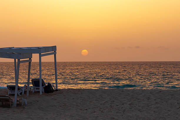 Parasol and two sunbeds on the beach